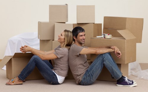 Packed boxes and furniture ready for transport in Rush Green