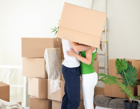 Removal staff loading office items with care