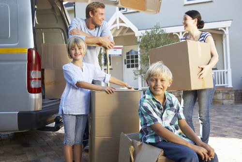 Professional movers handling furniture during a Rush Green home move