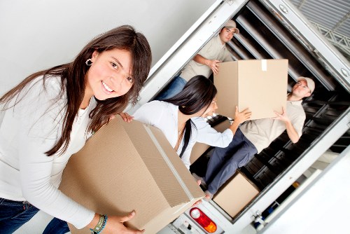 Relocation team unloading office furniture at a new site